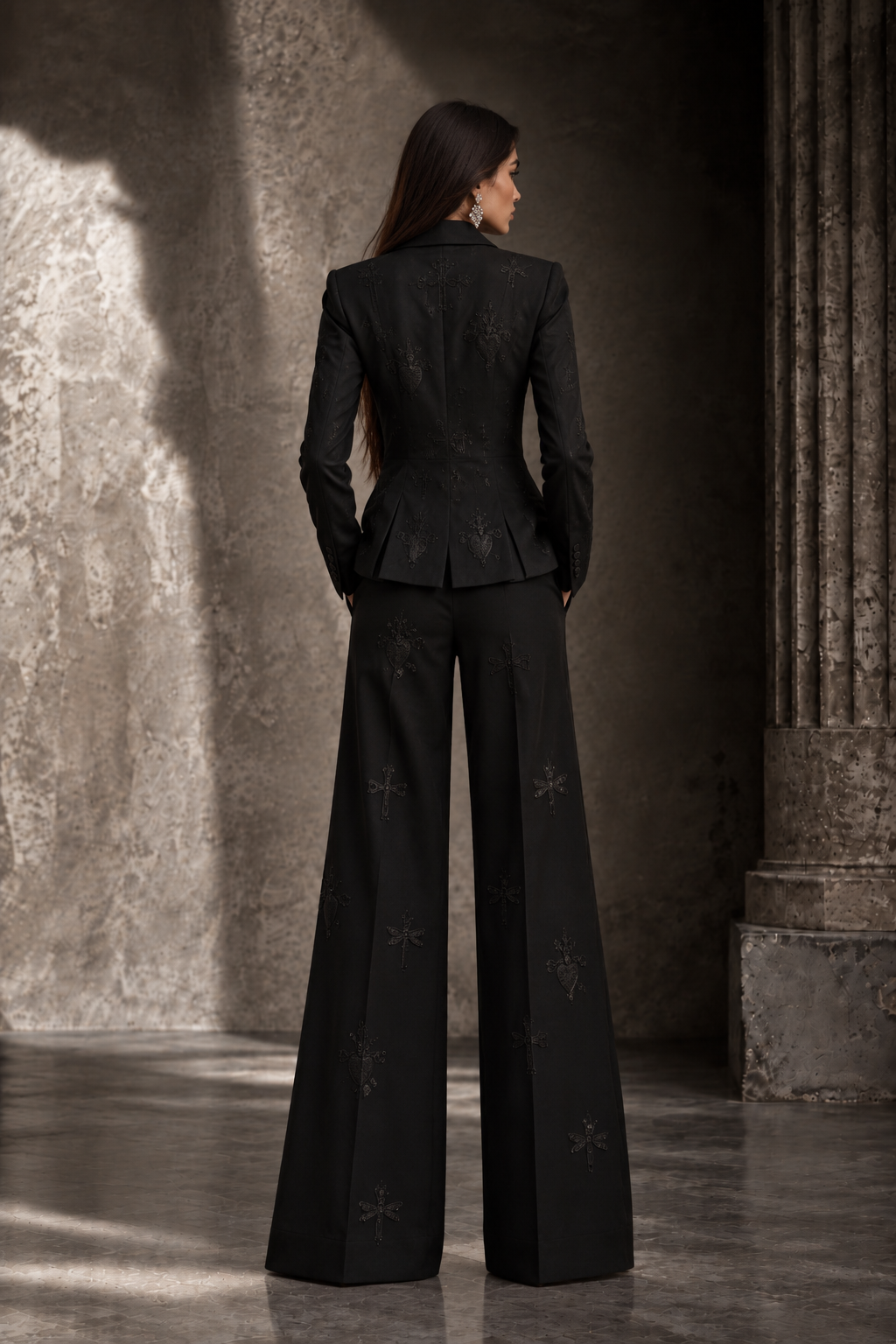 LIGNES D’OMBRE Embroidered Tuxedo Trouser Suit in black, full-length editorial view in architectural light.
