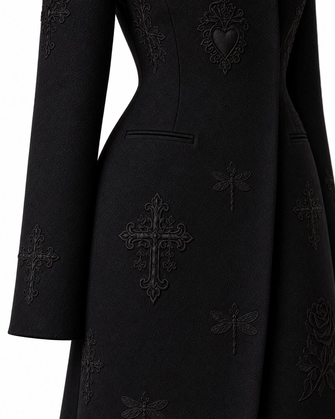 Close-up of the black long coat’s welt pocket, tailoring and tonal embroidery.