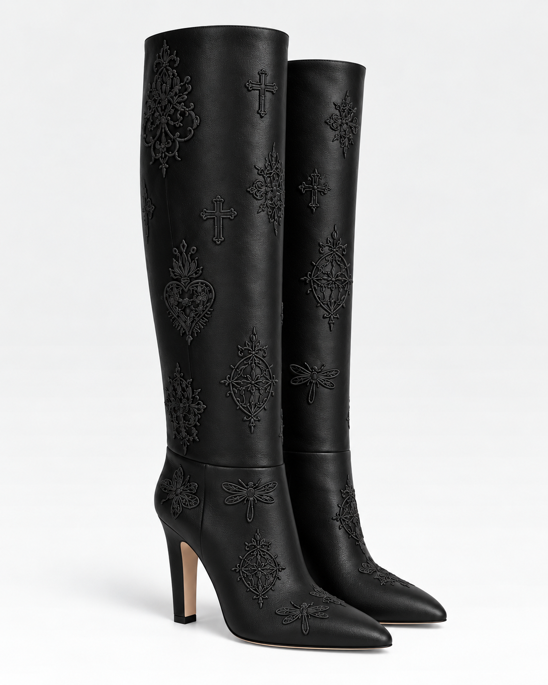 Three-quarter view of the black LIGNES D’OMBRE embroidered leather block-heel tall boots, showing pointed toes and tonal motifs.