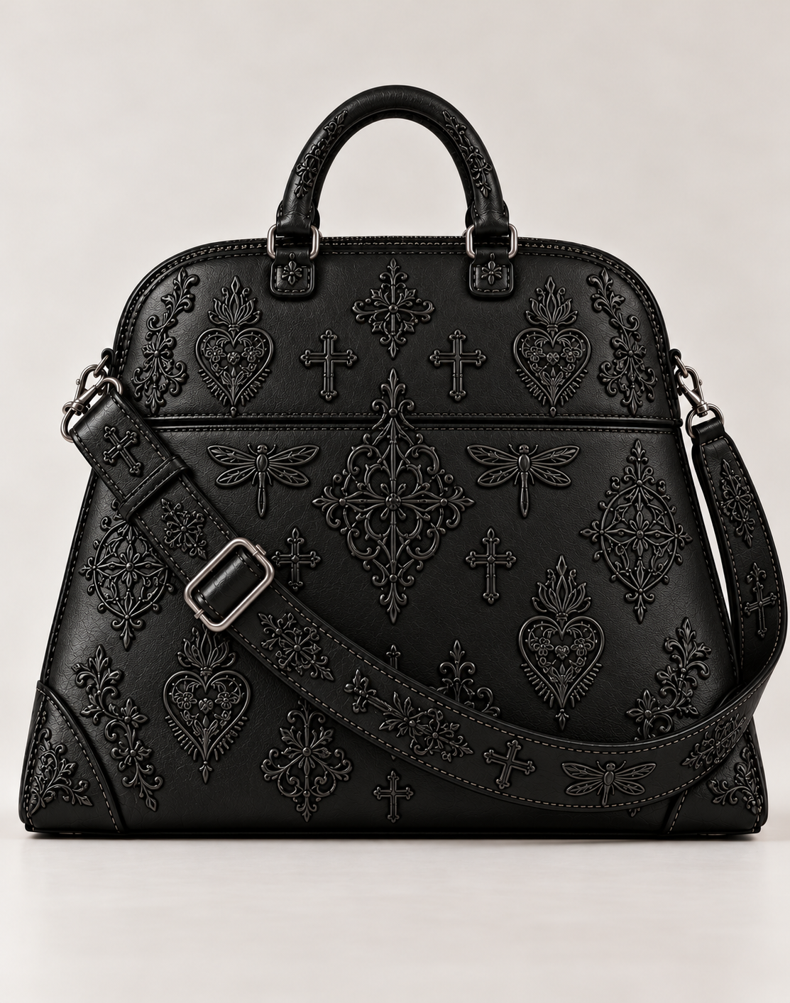 Front view of the LIGNES D’OMBRE embroidered structured handbag in black leather, showing rounded handles, tonal motifs and an adjustable shoulder strap.