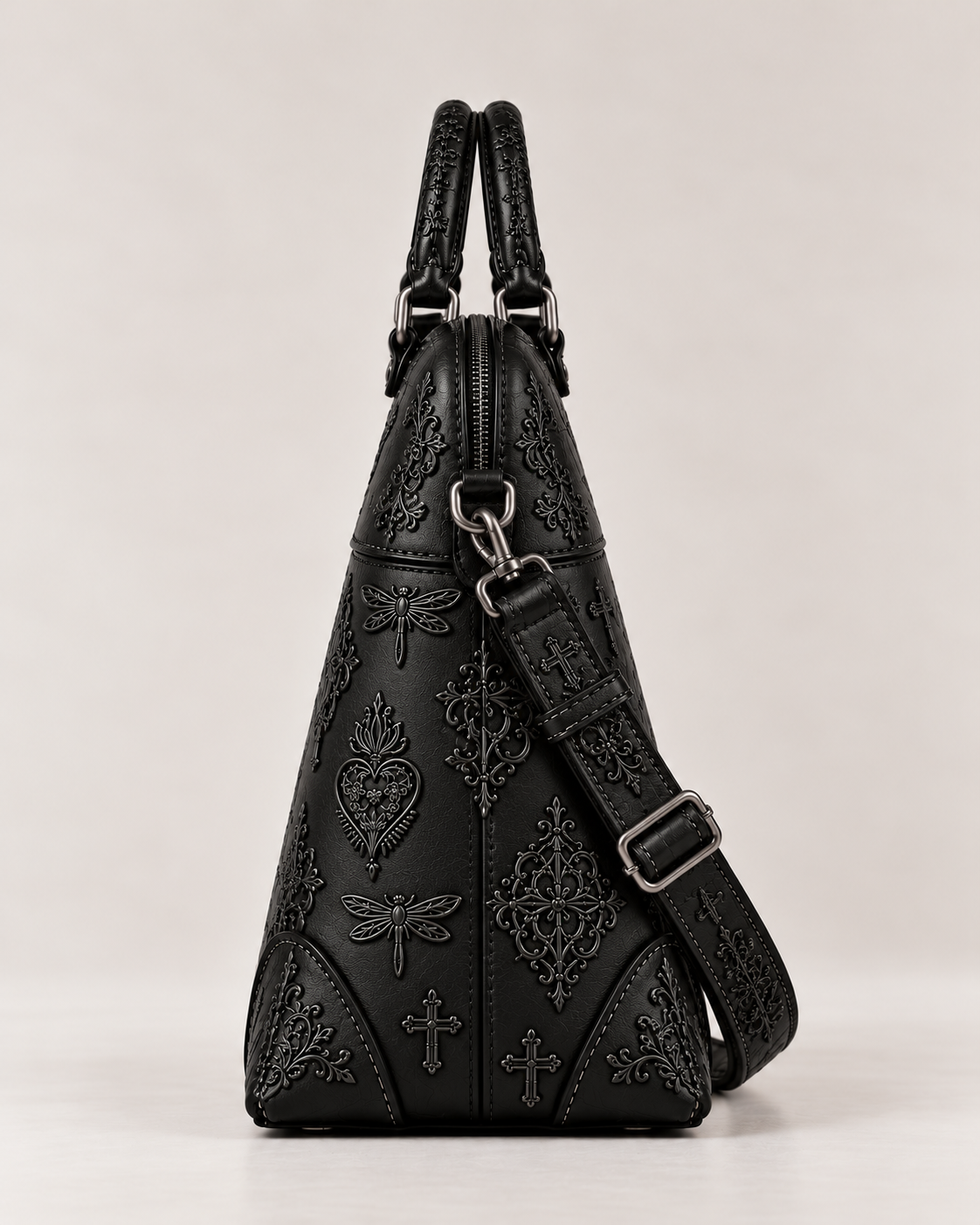 Side view of the black leather embroidered handbag, showing its structured shape, top zip and detachable strap attachment.