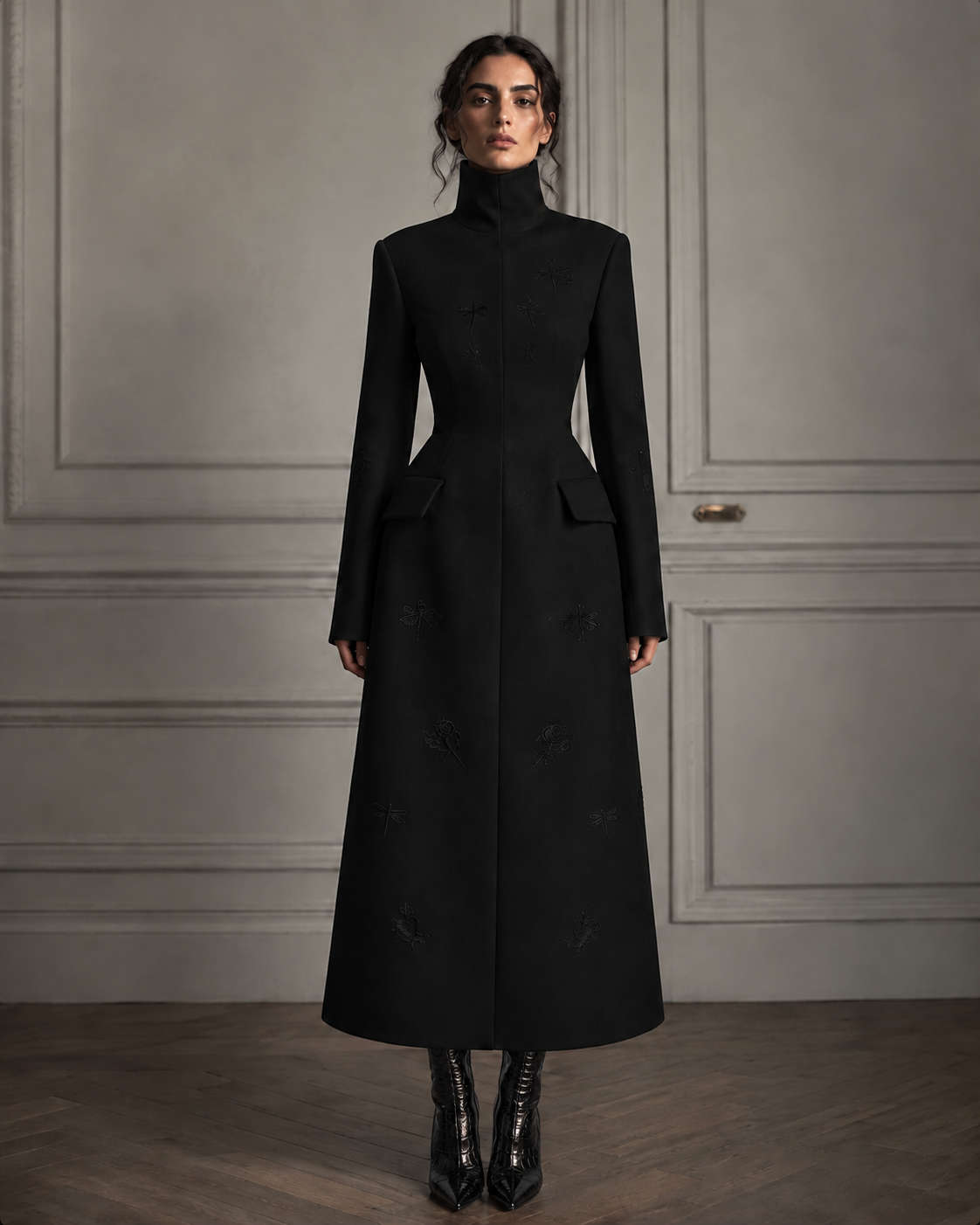 Front view of the black LIGNES D’OMBRE High-Collar Embroidered A-Line Coat, showing the shaped waist, flap pockets and flared silhouette.