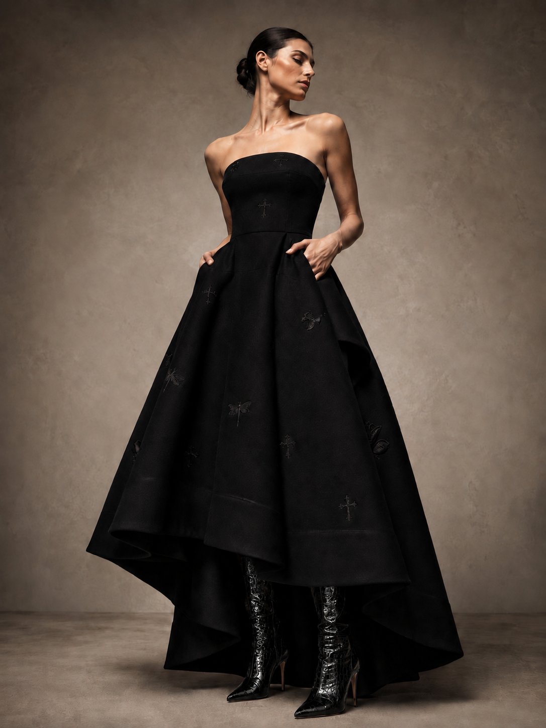 Front view of the black LIGNES D’OMBRE strapless embroidered high-low gown, showing the fitted bodice, full pleated skirt and longer back hem.