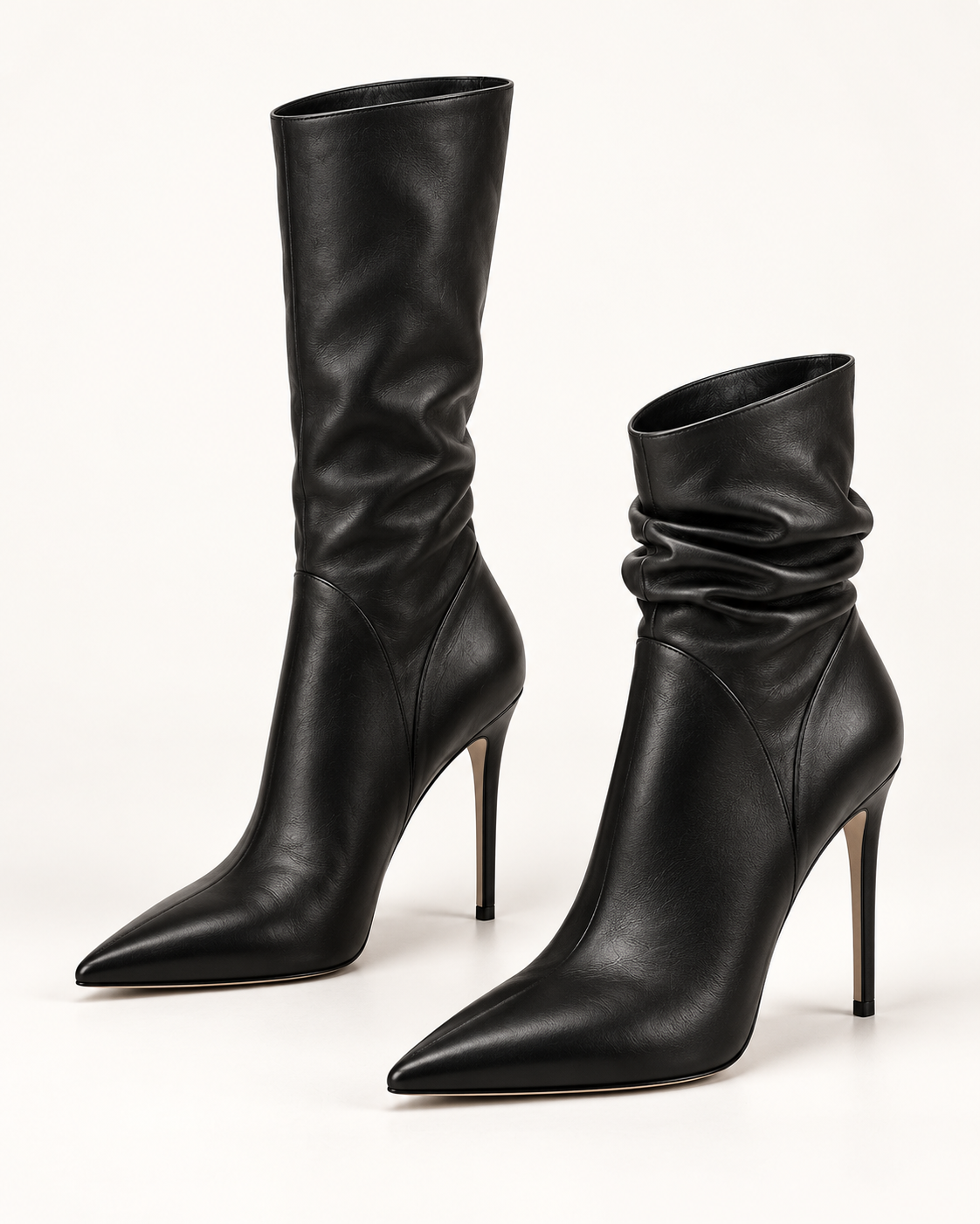 PLIS D’OMBRE black pointed-toe stiletto boots, with one shaft extended and the other gathered to show independently adjustable heights.