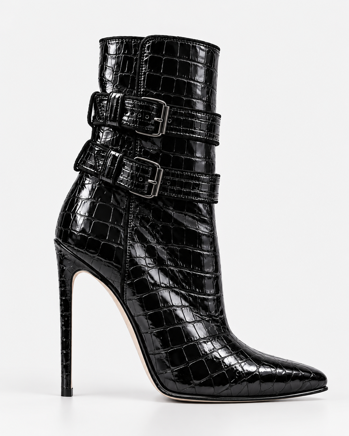 Side view of a black croc-effect ankle boot, showing the double buckled straps, pointed toe and slender stiletto heel.