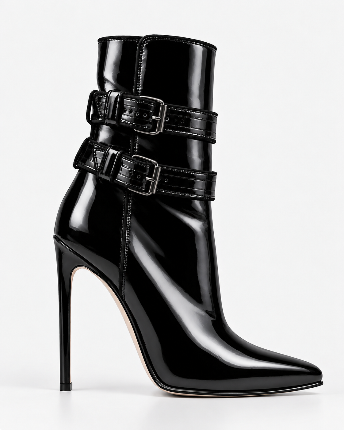 Side view of a glossy black double-buckle ankle boot, showing the two buckled straps, pointed toe and slender heel.